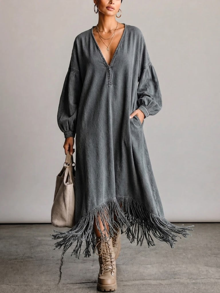 Washed, Distressed, Loose-fit Denim Dress Featuring A V-neck, Long Lantern Sleeves, And A Fringed Hem