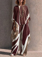 Two-piece Set Featuring An Asymmetrical Draped Top And Wide-leg Trousers With A Fluid Drape