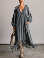 Washed, Distressed, Loose-fit Denim Dress Featuring A V-neck, Long Lantern Sleeves, And A Fringed Hem