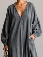 Washed, Distressed, Loose-fit Denim Dress Featuring A V-neck, Long Lantern Sleeves, And A Fringed Hem